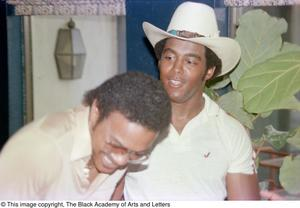 Photograph of Larry Whittington laughing while Tony Dorsett looks at him