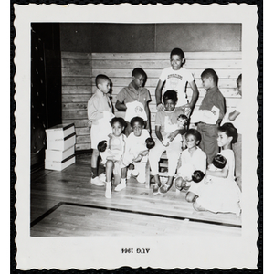 The Little Sister Contest winners hold their dolls while posing for a group picture with their brothers