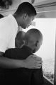 Thumbnail for North Carolina Volunteer and two children examining museum exhibit.