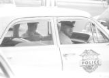 Eugene Harrison and another officer seated in a car during a student demonstration in Tuskegee, Alabama, to protest the murder of Samuel L. Younge, a civil rights worker.