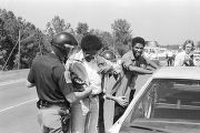 R. B. Cottonreader and another man being arrested by state troopers after participating in a march from Decatur to Cullman, Alabama, to protest the upcoming trial of Tommy Lee Hines.