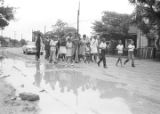 Richard Boone and others, marching through a neighborhood in Montgomery, Alabama, during a civil rights demonstration.