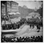 [Washington, D.C. Infantry unit with fixed bayonets followed by ambulances passing on Pennsylvania Avenue near the Treasury]