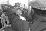 Female reporter listening to a man on Auburn Avenue on the day of Martin Luther King, Jr.'s funeral.