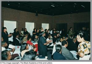 Photograph of a Tribute crowd looking at the off-screen stage