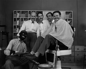 Four men and one man in blackface on barbershop set