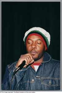 Photograph of a man holding a microphone up to his face