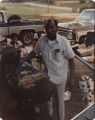 Members of the American Agriculture Movement eating and preparing barbecue at a gathering on Oscar Belvin’s farm in Montezuma, Georgia.