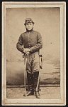 [Unidentified cavalryman in Union uniform with saber in front of painted backdrop showing landscape]