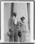 [Mr. and Mrs. Heman Sweatt, three-quarter length portrait, standing in front of building with large columns, probably the Supreme Court]