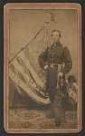 [Captain Jedediah Randall of Co. K, 26th Connecticut Infantry Regiment in uniform with sword in front of regimental flag]