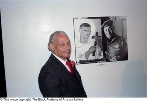 James Thibodeaux posing with his portrait