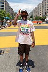 Gregory Adams poses on Black Lives Matter Mural on Black Lives Matter Plaza at the 2020 Juneteenth Celebration in Washington, D.C.