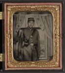 [Unidentified soldier in Union uniform with bayoneted musket in front of painted backdrop showing a window with curtains]