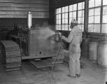 Employee spray painting equipment at the Ray-Brooks Machinery Company at 2275 West Fairview Avenue in Montgomery, Alabama.