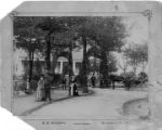 Unidentified family standing in front of a home with servants, horses, and a carriage.