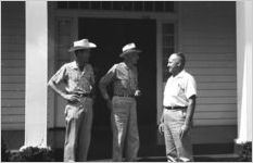 Three men on front porch