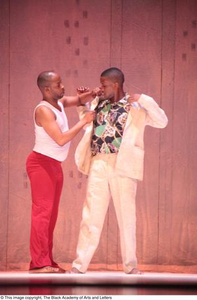 Dancer in red touching groom dancer