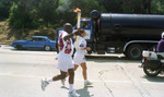 Lou Dantlzer running with the Olympic torch and flame, Los Angeles, 1996