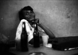 Woman seated at a table at Tom's Place at 648 South Holt Street in Montgomery, Alabama.