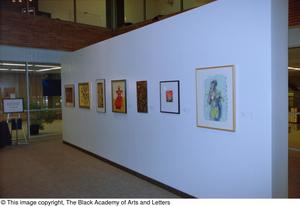 Photograph of an untitled gallery wall, featuring seven art works