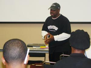 Man speaking at multicultural center hip hop event 2