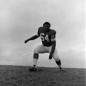 Football player squatting, 15