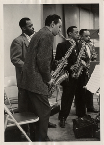 Left to right: Paul Gonsalves, Jimmy Hamilton, Johnny Hodges, Russell Procope, all playing saxophones : black-and-white photoprint