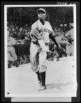 [Untitled photo shows: Satchel Paige, in the Kansas City Monarchs uniform at a baseball game]