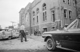 Damaged car and debris beside 16th Street Baptist Church in Birmingham, Alabama, after the building was bombed.