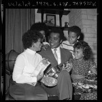 Thumbnail for Actor Greg Morris surrounded by his family, holding his Television Father of the Year award, 1971