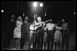 Bob Dylan leading performers on stage, Newport Folk Festival Left to right: Peter Yarrow, Mary Travers, Paul Stookey, Joan Baez, Bob Dylan, Bernice Reagon, Cordell Reagon, Charles Neblett, Rutha Harris, Pete Seeger