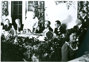 Photograph of a member of the Georgia Warm Springs Foundation staff presenting a dinner entrée to Franklin Delano Roosevelt during a Thanksgiving celebration at the Georgia Warm Springs Foundation, Warm Springs, Meriwether County, Georgia