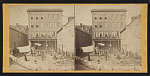 [African American residents standing in back court of tenement house]