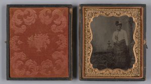 Tintype of a woman wearing a white hat and holding a book