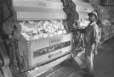 Man operating a cotton gin near Mount Meigs in Montgomery County, Alabama.