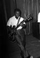 Chico Jenkins, a member of Bobby Moore and the Rhythm Aces, playing a guitar on stage during a New Year's celebration at the Laicos Club in Montgomery, Alabama.