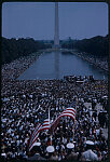 [View from the steps of the Lincoln Memorial of crowds of people, some with American flags, during the1963 March on Washington for Jobs and Freedom]