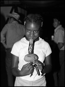 Young Visitor Eating Sausage on a Stick