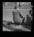 Detroit, Michigan. Riot at the Sojourner Truth homes, a new U.S. federal housing project, caused by white neighbors' attempt to prevent Negro tenants from moving in. Back view of typical newspaper photographer