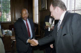 Congressman John Lewis shaking hands with a man before or after an award presentation to photographer Spider Martin by the Black Heritage Council of the Alabama Historical Commission.