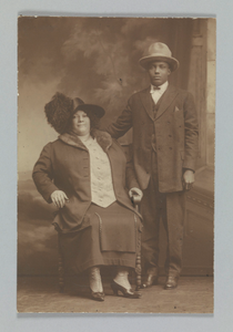 Photographic print of a woman sitting and a man standing