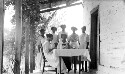 Girls serving dinner to teachers on porch. Beaver Dam Home Makers Club