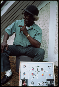 Outsider art: Theodore Hill. Theodore Hill with one of his visual art pieces