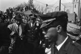 Police escorting Jacqueline Kennedy (hidden from view) down Auburn Avenue to Ebenezer Baptist Church for Martin Luther King, Jr.'s funeral.