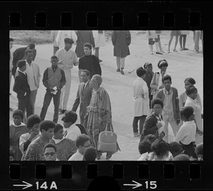 Speakers, most likely Black community leaders or activists, seen in middle of group during Black student rally in Franklin Park