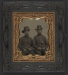 [Unidentified soldiers in Union uniforms and infantry Company B Hardee hats; soldier on left holds fife and soldier on right wears locket and key around his neck]