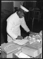 Dining car worker checking inventory, 14th Street passenger yards, Chicago, May 1948