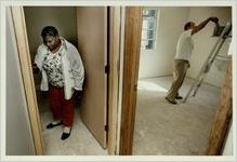 Rose Ann Dudley varnishes trim in her new Summerhill home, October 19, 1991