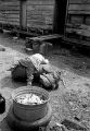 Two children of John Nixon playing on a metal barrel in their yard in Autaugaville, Alabama.